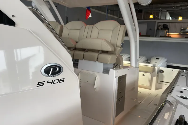 Slide: The Image of 2019 Pursuit S 408 Sport boat interior with seating and storage compartments. - 37