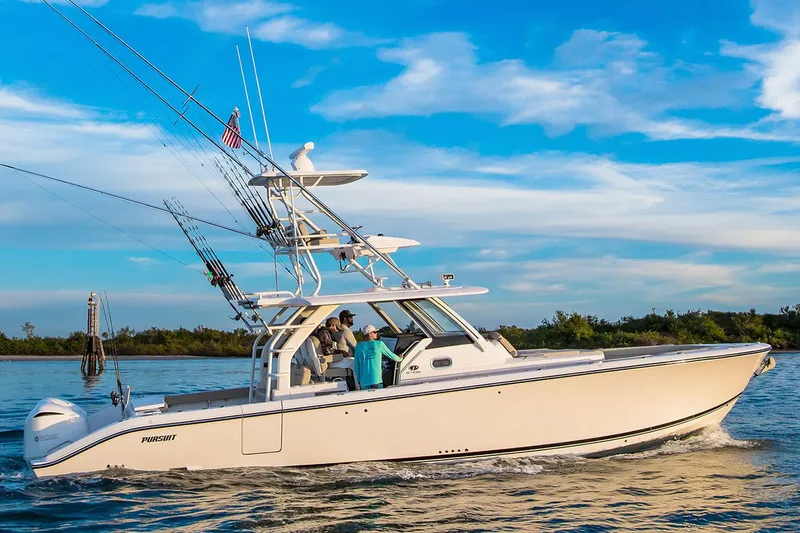 Slide: The Image of 2019 Pursuit S 408 Sport boat cruising on a calm lake under a clear blue sky. - 4
