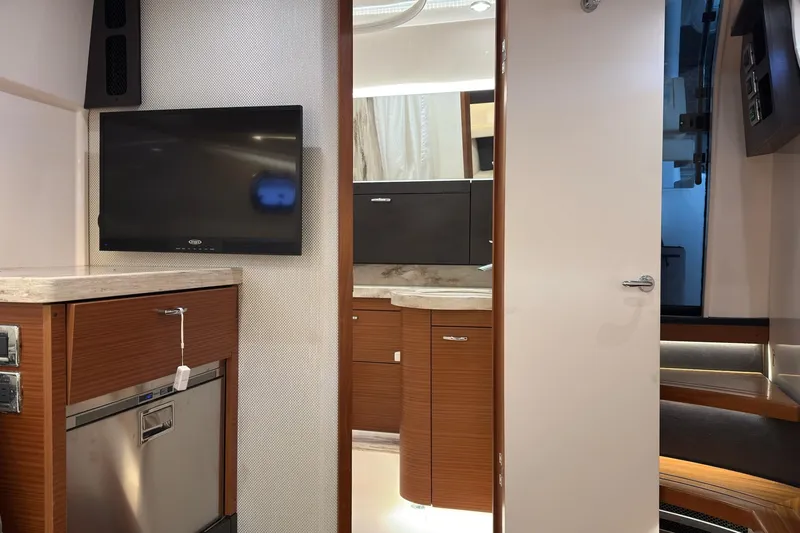 Slide: The Image of 2019 Pursuit S 408 Sport yacht interior with TV, cabinetry, and modern design. - 40