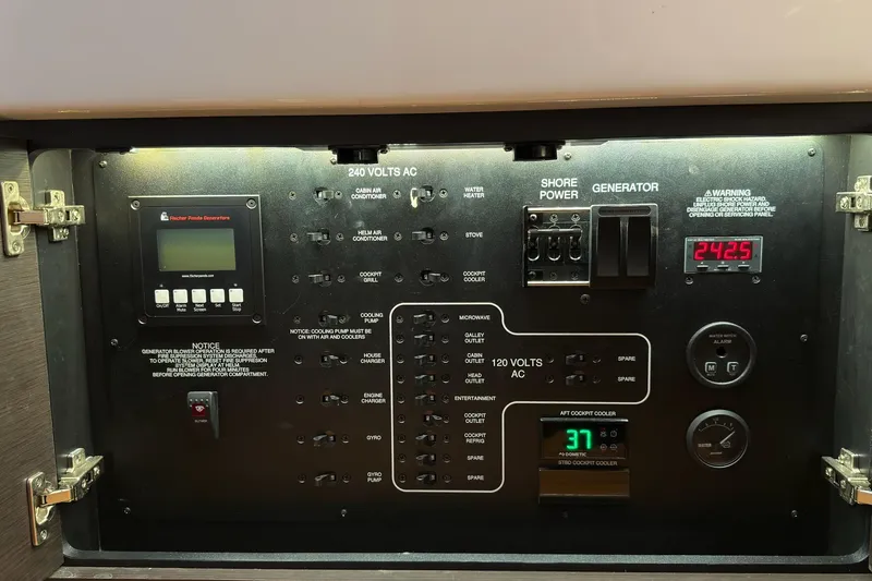 Slide: The Image of Electrical control panel of a 2019 Pursuit S 408 Sport boat, featuring various switches and meters. - 43