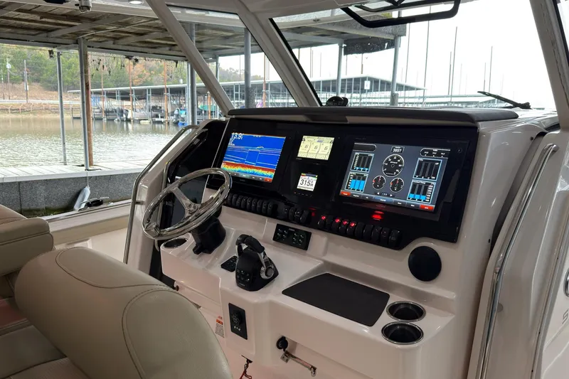 Slide: The Image of 2019 Pursuit S 408 Sport boat dashboard with advanced navigation and control systems. - 48