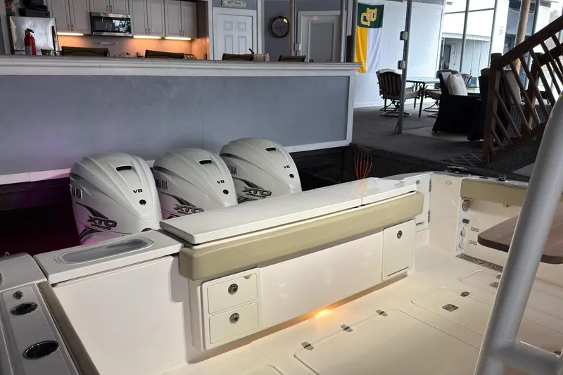 Slide: The Image of 2019 Pursuit S 408 Sport boat with Yamaha XTO V8 engines docked indoors. - 52