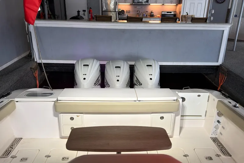 Slide: The Image of 2019 Pursuit S 408 Sport boat with triple V8 engines in a garage setting. - 53