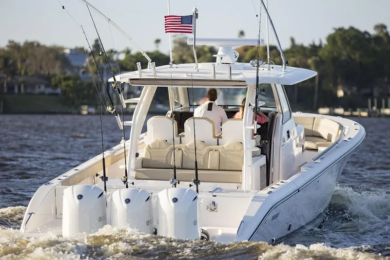 Slide: The Image of Manufacturer Provided Image: 2019 Pursuit S 408 Sport boat cruising on water with fishing rods. - 6
