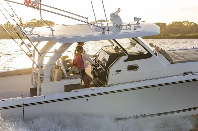 Slide: The Image of Manufacturer Provided Image: 2019 Pursuit S 408 Sport boat cruising on the water at sunset. - 8