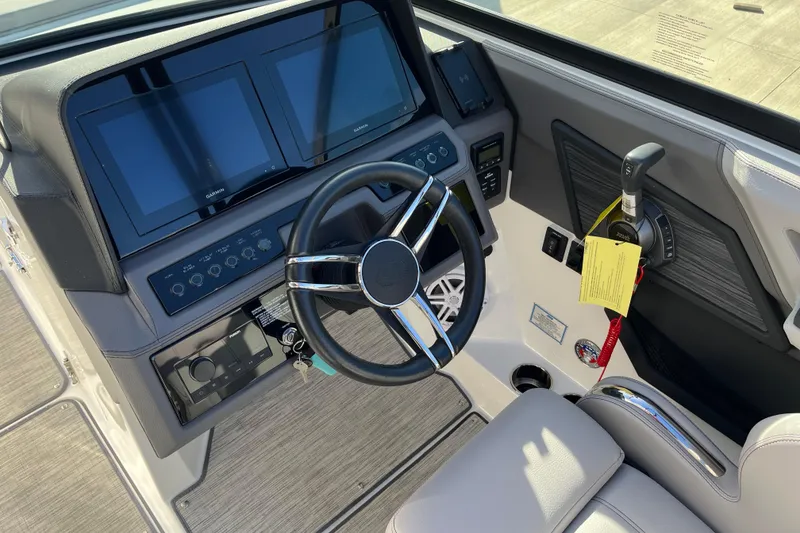 Slide: The Image of 2022 Cobalt R8 boat dashboard with dual Garmin screens and modern steering wheel. - 10
