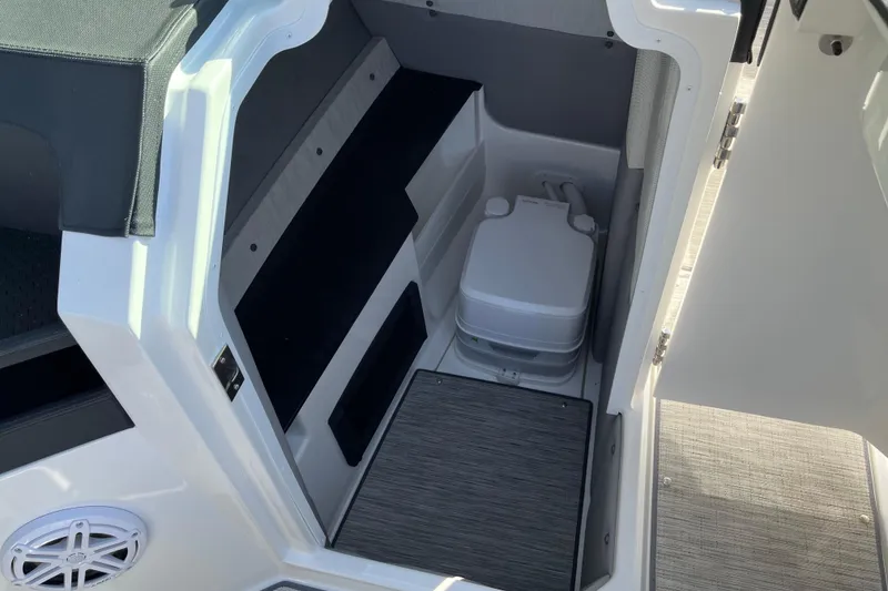 Slide: The Image of 2022 Cobalt R8 boat interior with compact toilet and seating area. - 12