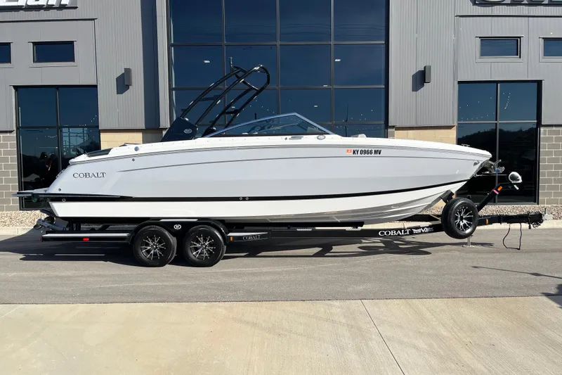 Slide: The Image of 2022 Cobalt R8 boat on trailer, parked outside a modern building. - 3