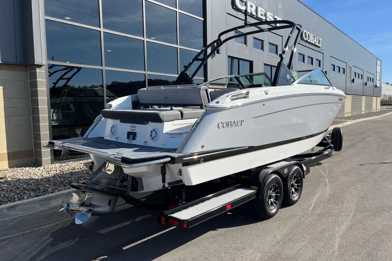 Slide: The Image of 2022 Cobalt R8 boat on trailer outside dealership, showcasing sleek design and modern features. - 4