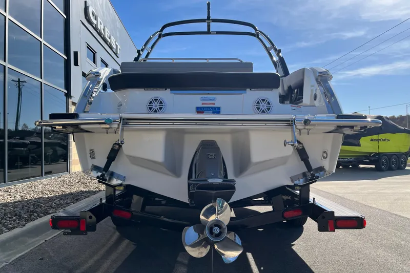 Slide: The Image of 2022 Cobalt R8 boat rear view, parked outside dealership, showcasing propeller and sleek design. - 5