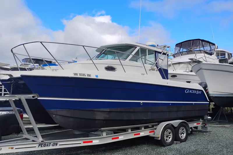 The Image of 2007 Glacier Bay 2685 Coastal Runner boat on trailer, blue and white design. - 0