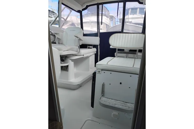 Slide: The Image of Interior of 2007 Glacier Bay 2685 Coastal Runner boat with white seating and helm. - 13