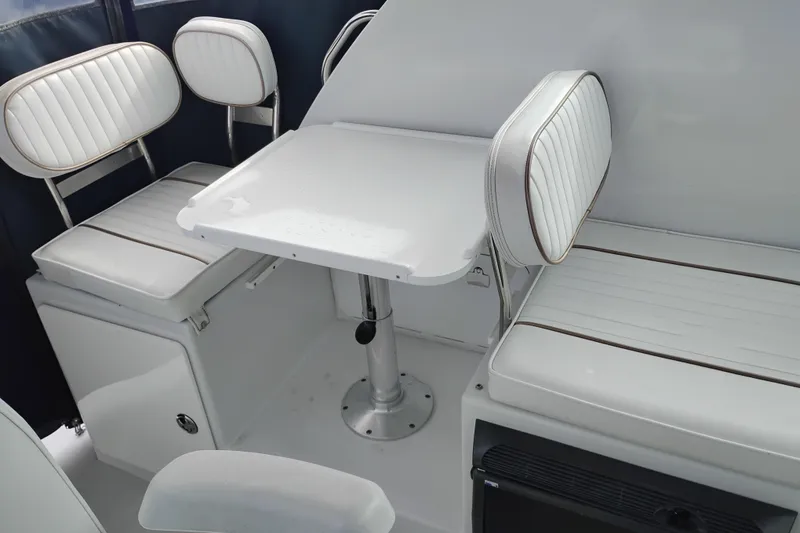 Slide: The Image of 2007 Glacier Bay 2685 Coastal Runner interior with white seating and table. - 14