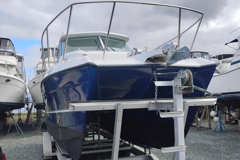 Slide: The Image of 2007 Glacier Bay 2685 Coastal Runner boat on trailer, surrounded by other boats. - 2