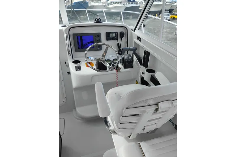 Slide: The Image of 2007 Glacier Bay 2685 Coastal Runner helm with steering wheel and navigation equipment. - 20