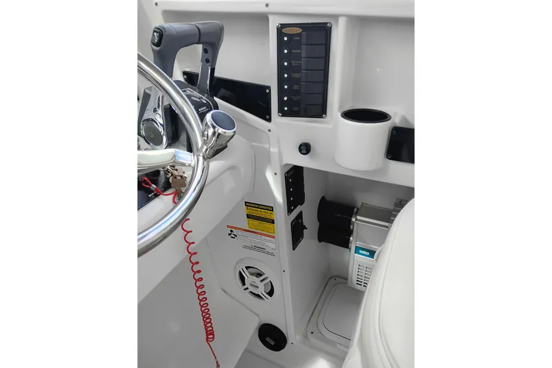 Slide: The Image of 2007 Glacier Bay 2685 Coastal Runner helm with controls and cup holder. - 23