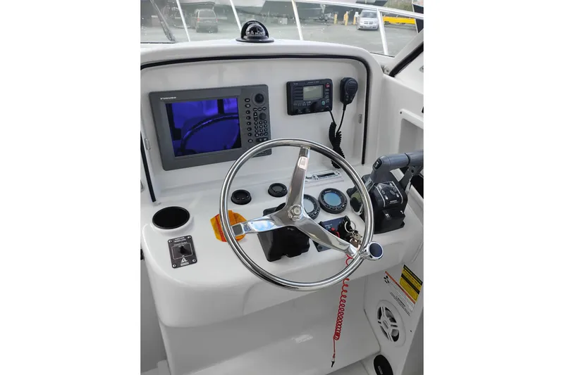 Slide: The Image of 2007 Glacier Bay 2685 Coastal Runner helm with steering wheel and navigation instruments. - 25