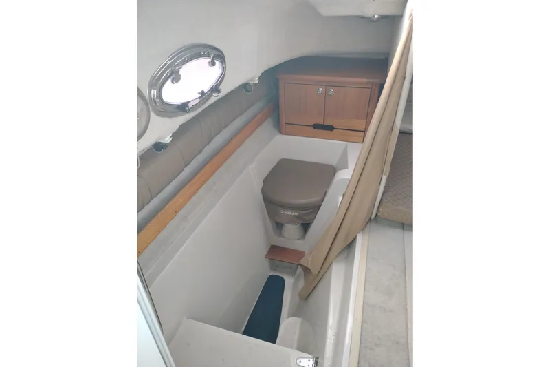 Slide: The Image of 2007 Glacier Bay 2685 Coastal Runner cabin interior with compact toilet and storage. - 30