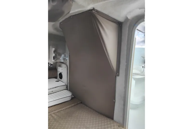 Slide: The Image of Interior of 2007 Glacier Bay 2685 Coastal Runner boat, featuring cabin seating and storage. - 31