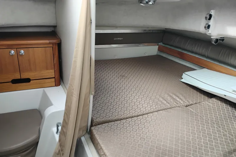 Slide: The Image of 2007 Glacier Bay 2685 Coastal Runner cabin interior with bed and wooden storage. - 32