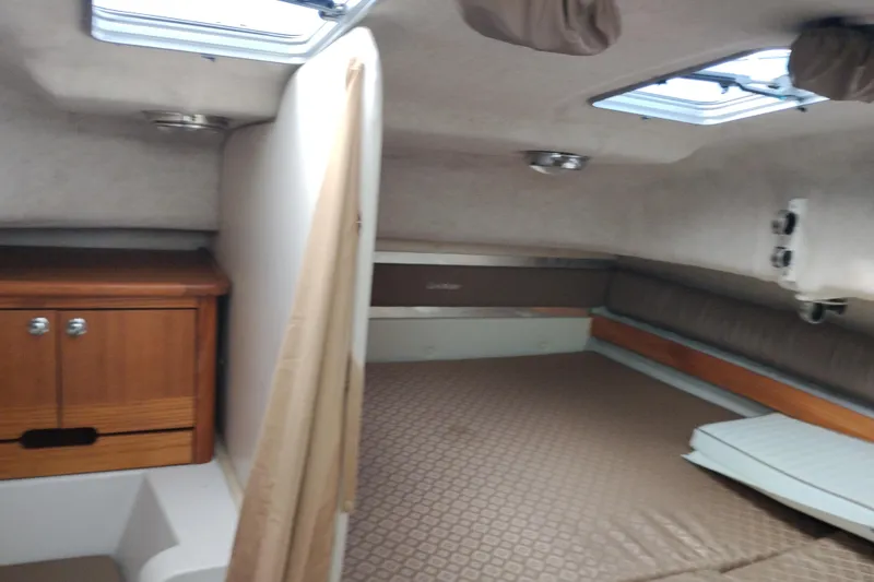 Slide: The Image of 2007 Glacier Bay 2685 Coastal Runner cabin interior with bed and wooden storage. - 35