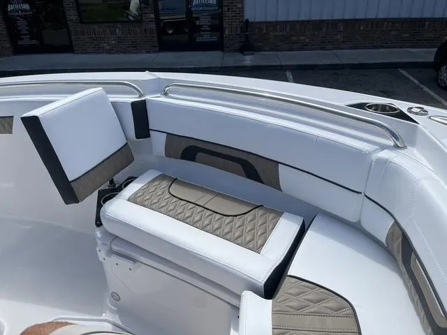 Slide: The Image of 2024 Blackfin 222CC boat interior with white and tan cushioned seating. - 10