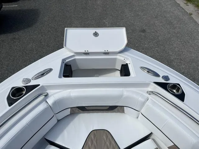 Slide: The Image of 2024 Blackfin 222CC boat interior with open storage compartment and cushioned seating. - 11