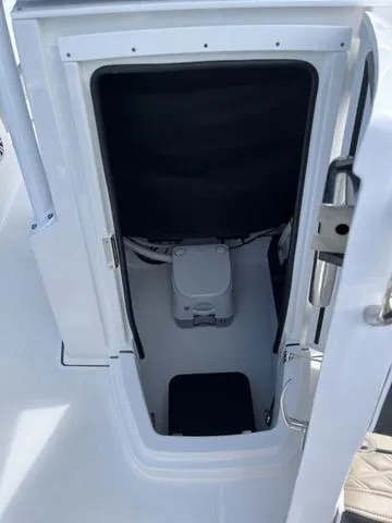 Slide: The Image of 2024 Blackfin 222CC boat interior with compact marine toilet. - 13