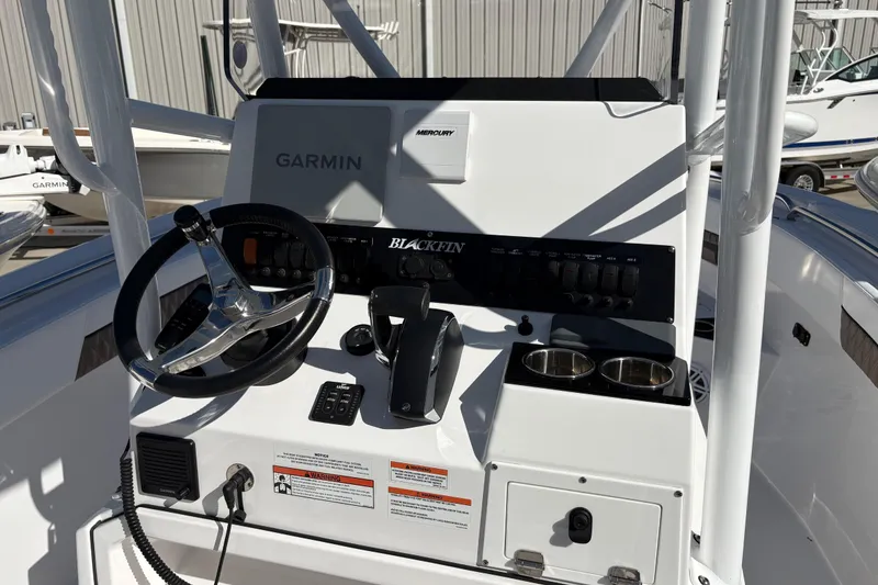 Slide: The Image of 2024 Blackfin 222CC boat console with Garmin display and Mercury controls. - 15