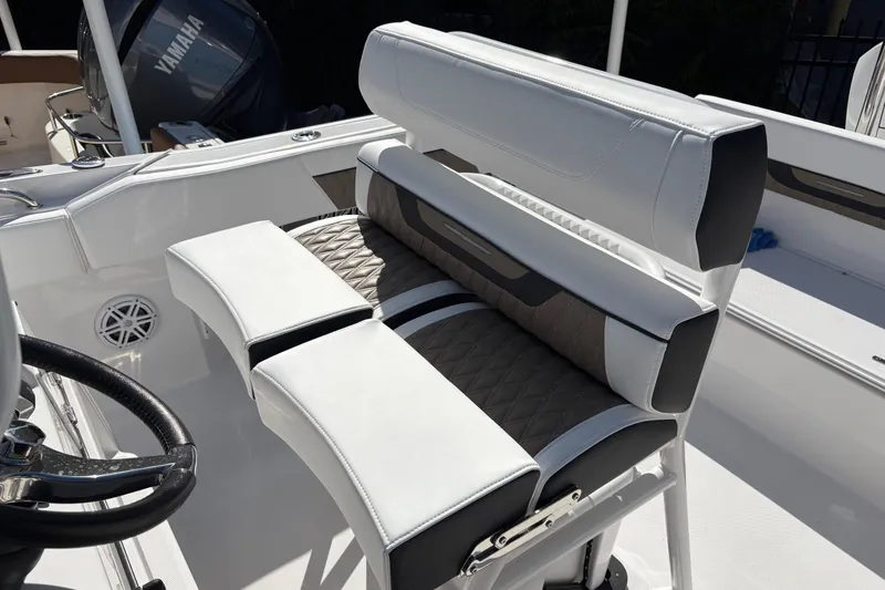 Slide: The Image of 2024 Blackfin 222CC boat interior with white and gray seating, featuring a Yamaha engine. - 18