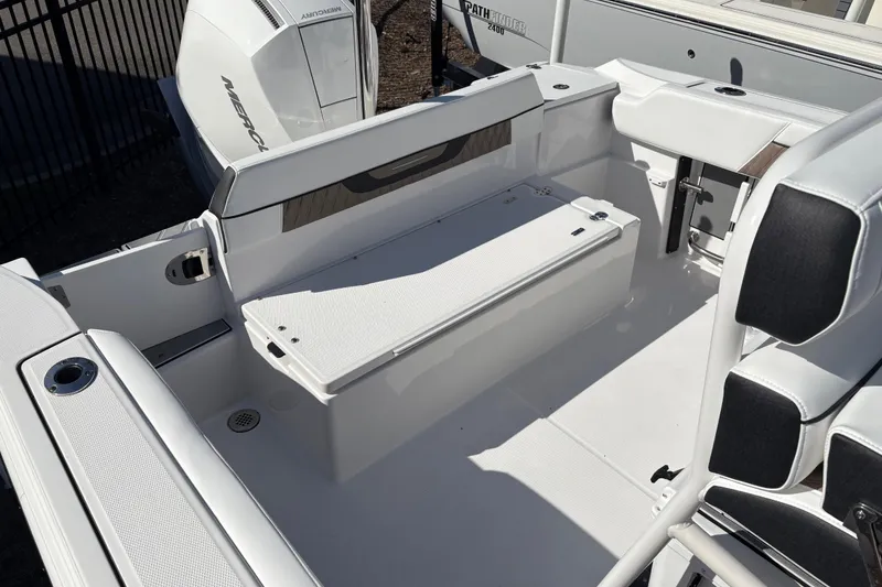 Slide: The Image of 2024 Blackfin 222CC boat interior with seating and storage, featuring a Mercury engine. - 19