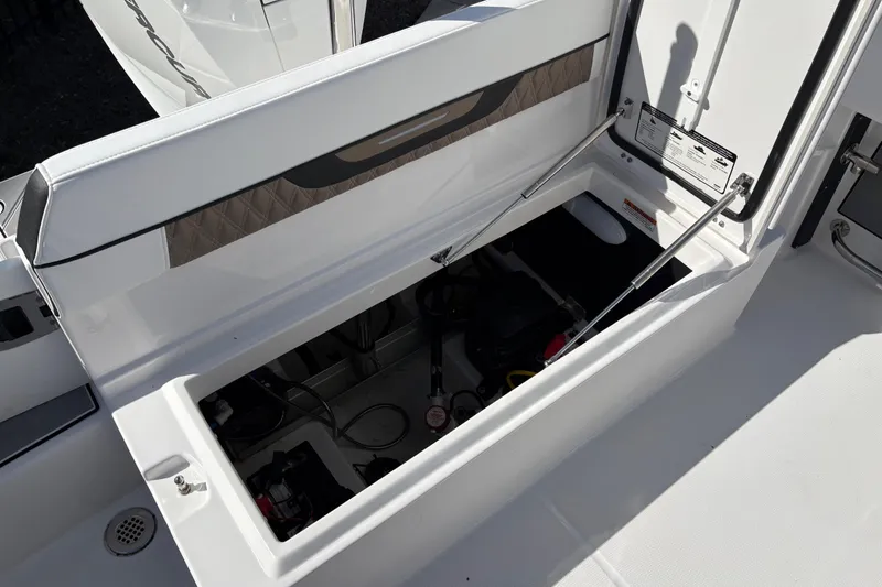 Slide: The Image of 2024 Blackfin 222CC boat storage compartment with open hatch, showcasing interior details. - 21