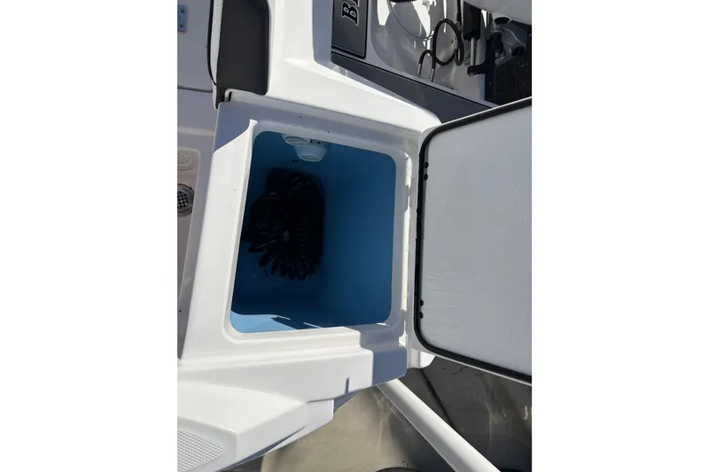 Slide: The Image of Open storage compartment on 2024 Blackfin 222CC boat, showing interior space. - 25