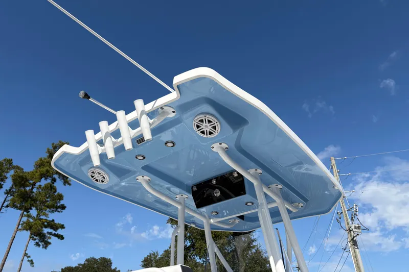Slide: The Image of 2024 Blackfin 222CC boat top view with speakers and rod holders against blue sky. - 27