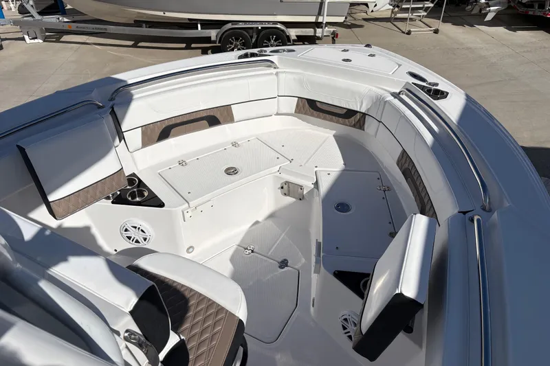 Slide: The Image of 2024 Blackfin 222CC boat interior with white seating and storage compartments. - 5