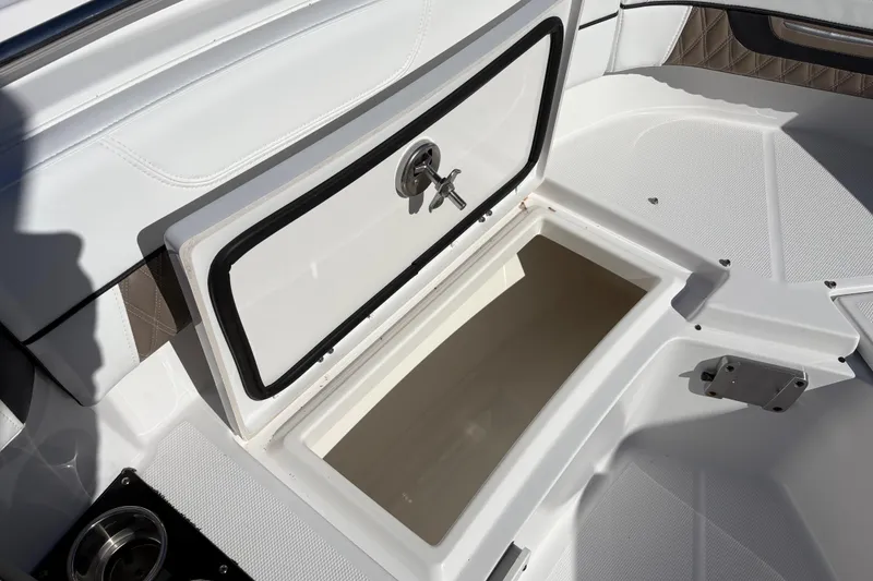 Slide: The Image of 2024 Blackfin 222CC boat storage compartment with open hatch, showcasing interior space. - 8