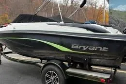 Slide: The Image of 2015 Bryant 198 Walkabout boat on trailer, black and white design with green accents. - 4
