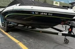 Slide: The Image of 2015 Bryant 198 Walkabout boat on trailer, black and white exterior, parked on pavement. - 6