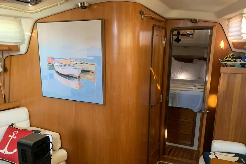 Slide: The Image of Interior of a 2003 Catalina 350 sailboat with wooden paneling and nautical decor. - 2