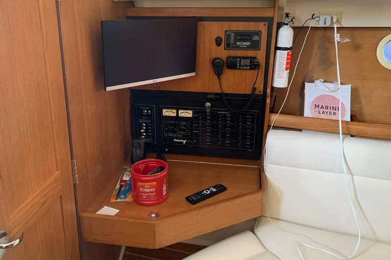 Slide: The Image of Navigation station in a 2003 Catalina 350 sailboat with control panel and equipment. - 4
