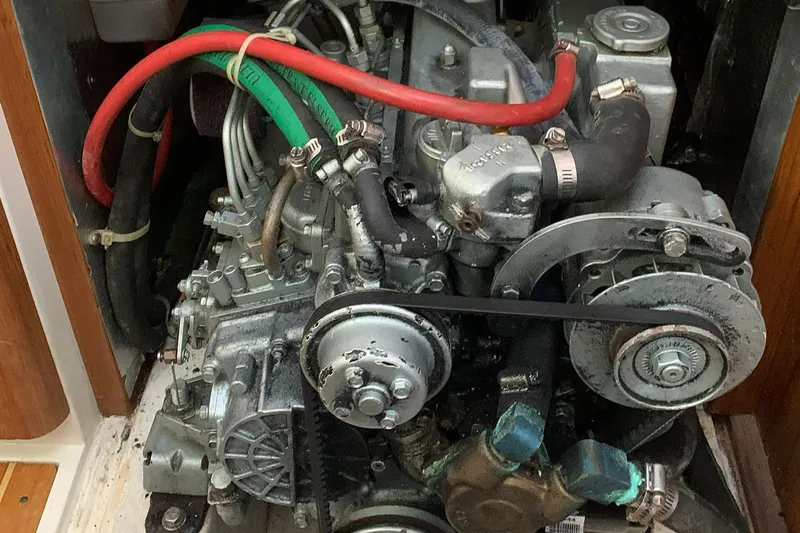 Slide: The Image of Engine compartment of a 2003 Catalina 350 sailboat, showing mechanical components and hoses. - 5
