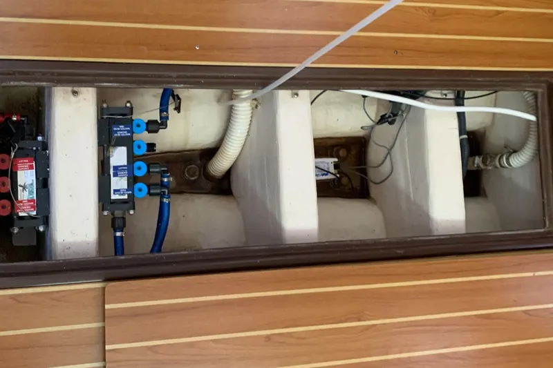 Slide: The Image of Underfloor compartment of a 2003 Catalina 350 sailboat, showing wiring and plumbing. - 6