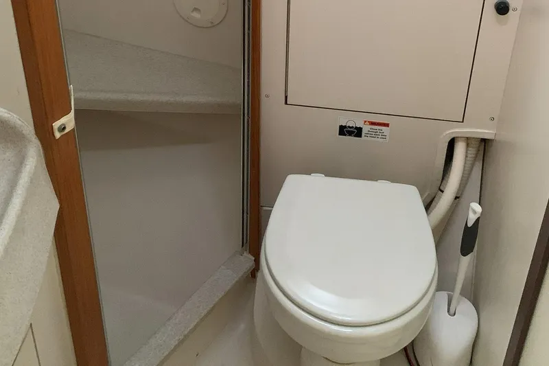 Slide: The Image of 2003 Catalina 350 yacht bathroom with toilet and storage compartment. - 8