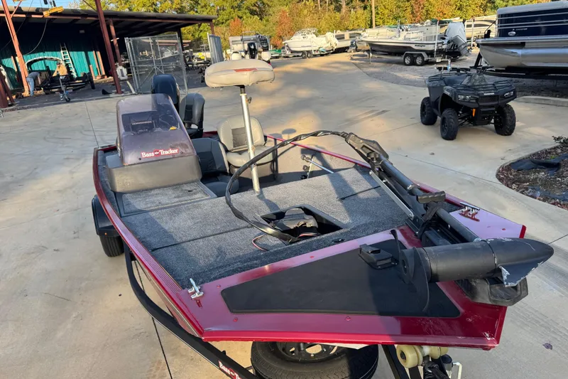 Slide: The Image of 2020 Bass Tracker Classic fishing boat in a marina with other boats and vehicles. - 4