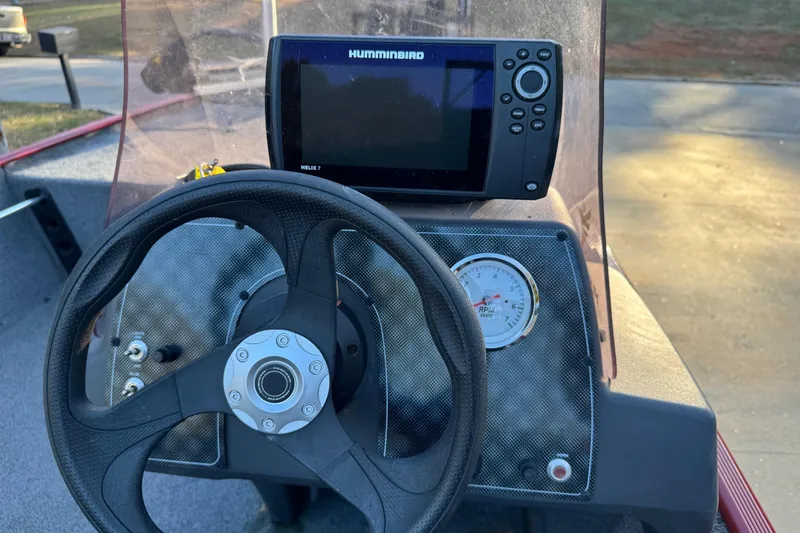 Slide: The Image of 2020 Bass Tracker Classic boat dashboard with steering wheel and Humminbird Helix 7 fish finder. - 5