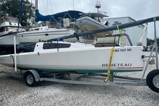 Slide: The Image of 2022 Beneteau First 24 SE sailboat on trailer, parked in a marina. - 13