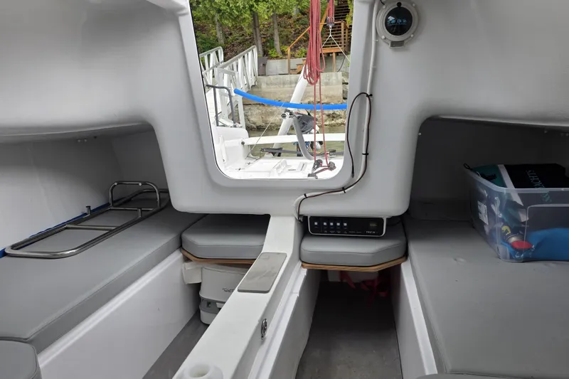 Slide: The Image of Interior of 2022 Beneteau First 24 SE sailboat, featuring seating and storage areas. - 2