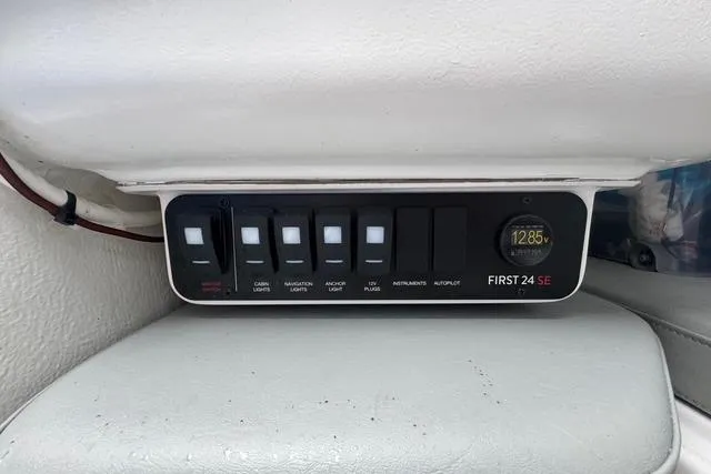 Slide: The Image of Control panel of 2022 Beneteau First 24 SE sailboat with switches and voltage display. - 27