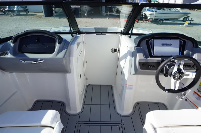 Slide: The Image of Interior view of 2026 Chaparral 23 SSi OB boat, featuring modern dashboard and steering wheel. - 18