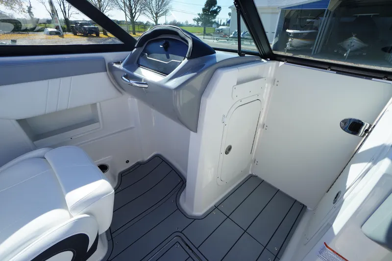 Slide: The Image of 2026 Chaparral 23 SSi OB boat interior with sleek design and modern dashboard. - 26